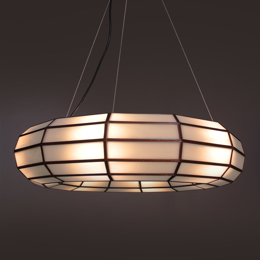 Decorative pendant light with geometric design on a dark background