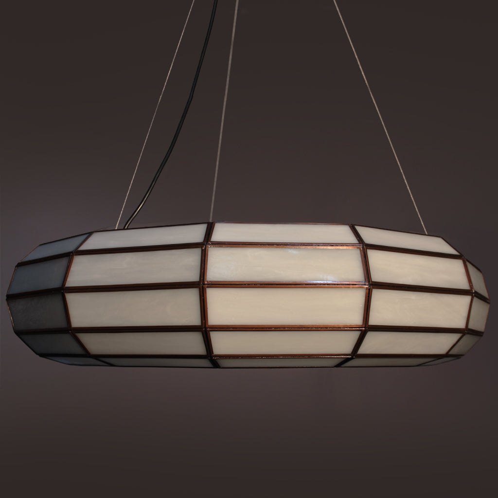Round pendant light with white glass design on a dark background