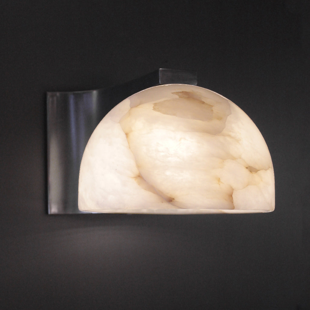 Wall-mounted light fixture with marble-like shade on a dark background