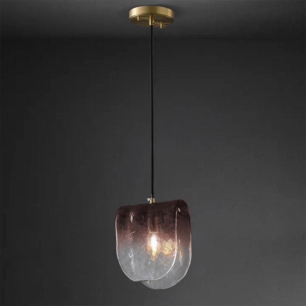 Modern pendant light with a glass shade on a dark background