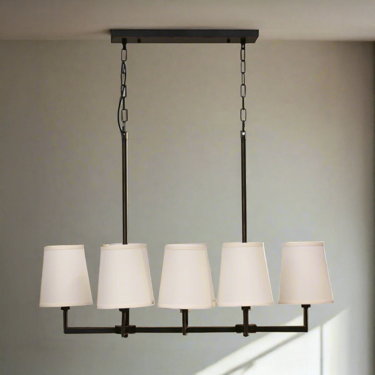 Ceiling light fixture with white lampshades on a neutral background
