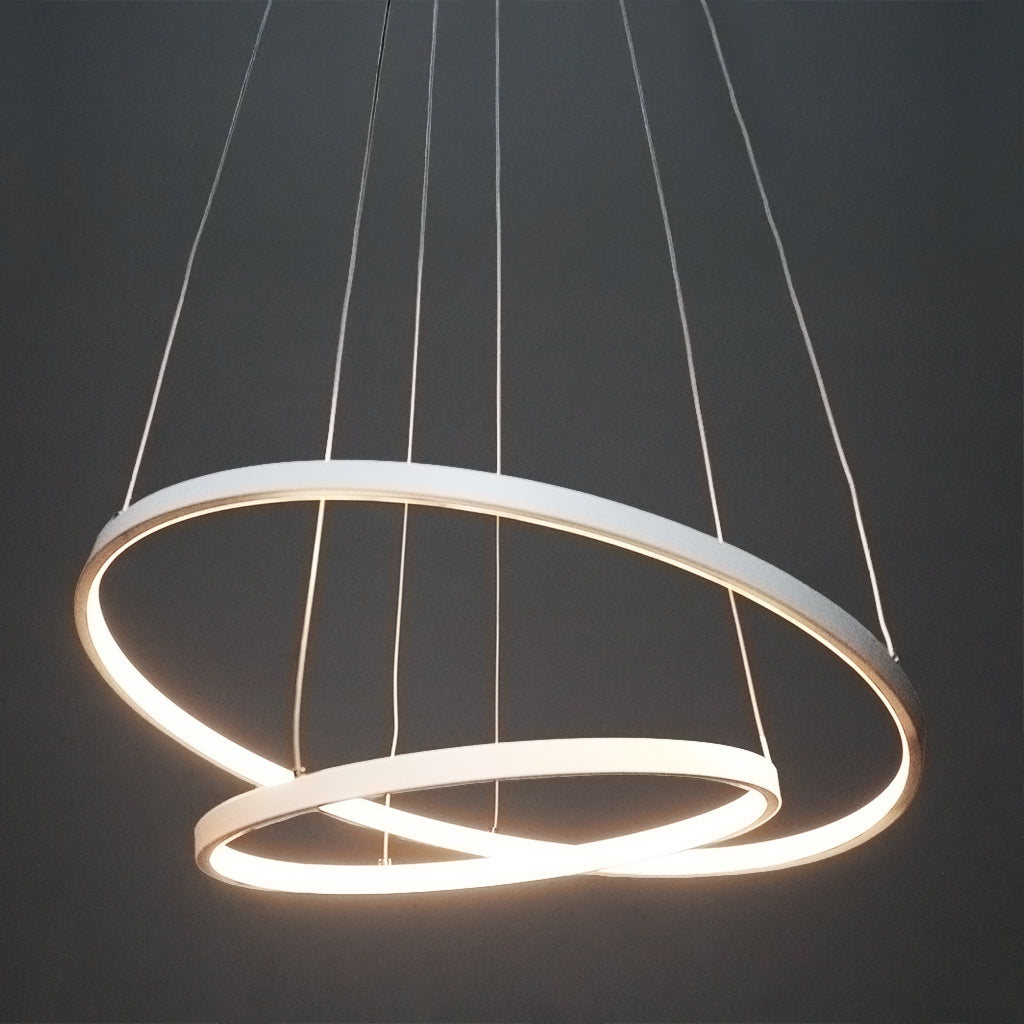 Modern pendant light with two interlocking rings on a dark background