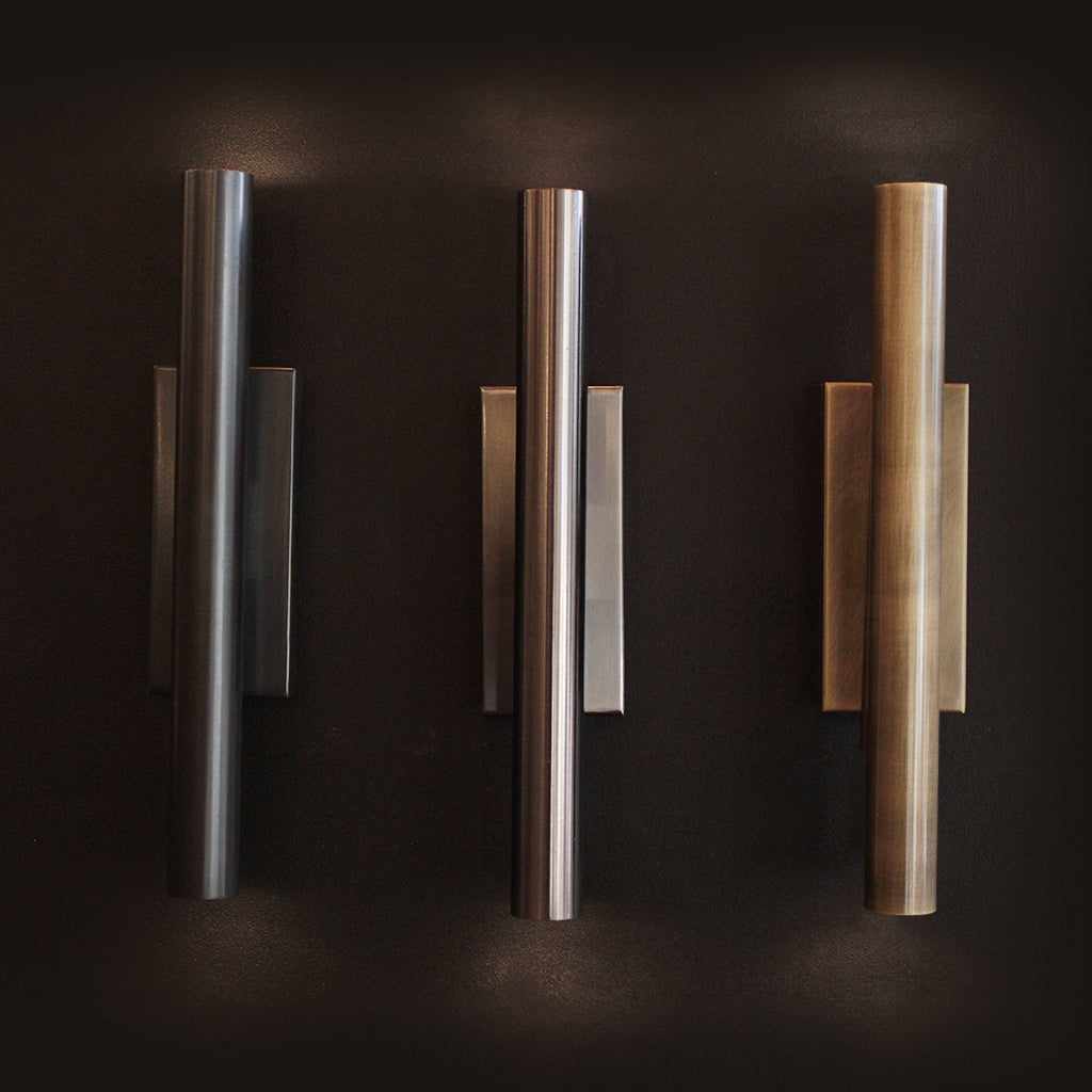 Three wall lights in varying finishes