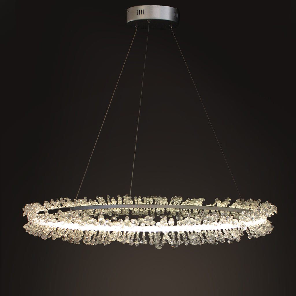 A modern circular LED chandelier with clear crystal beading, suspended from a silver ceiling canopy against a dark background.