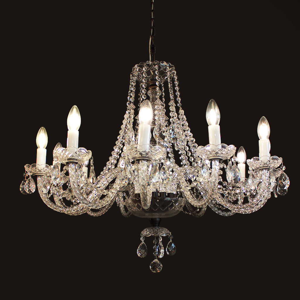 Crystal chandelier with twelve lights on a black background