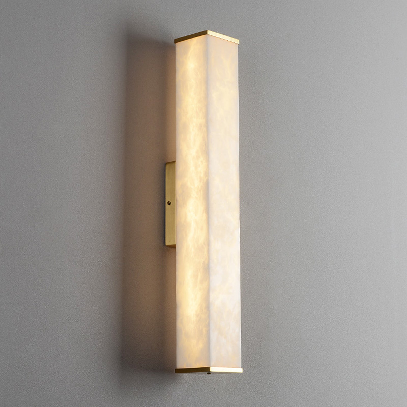 Modern wall sconce light fixture on a gray wall