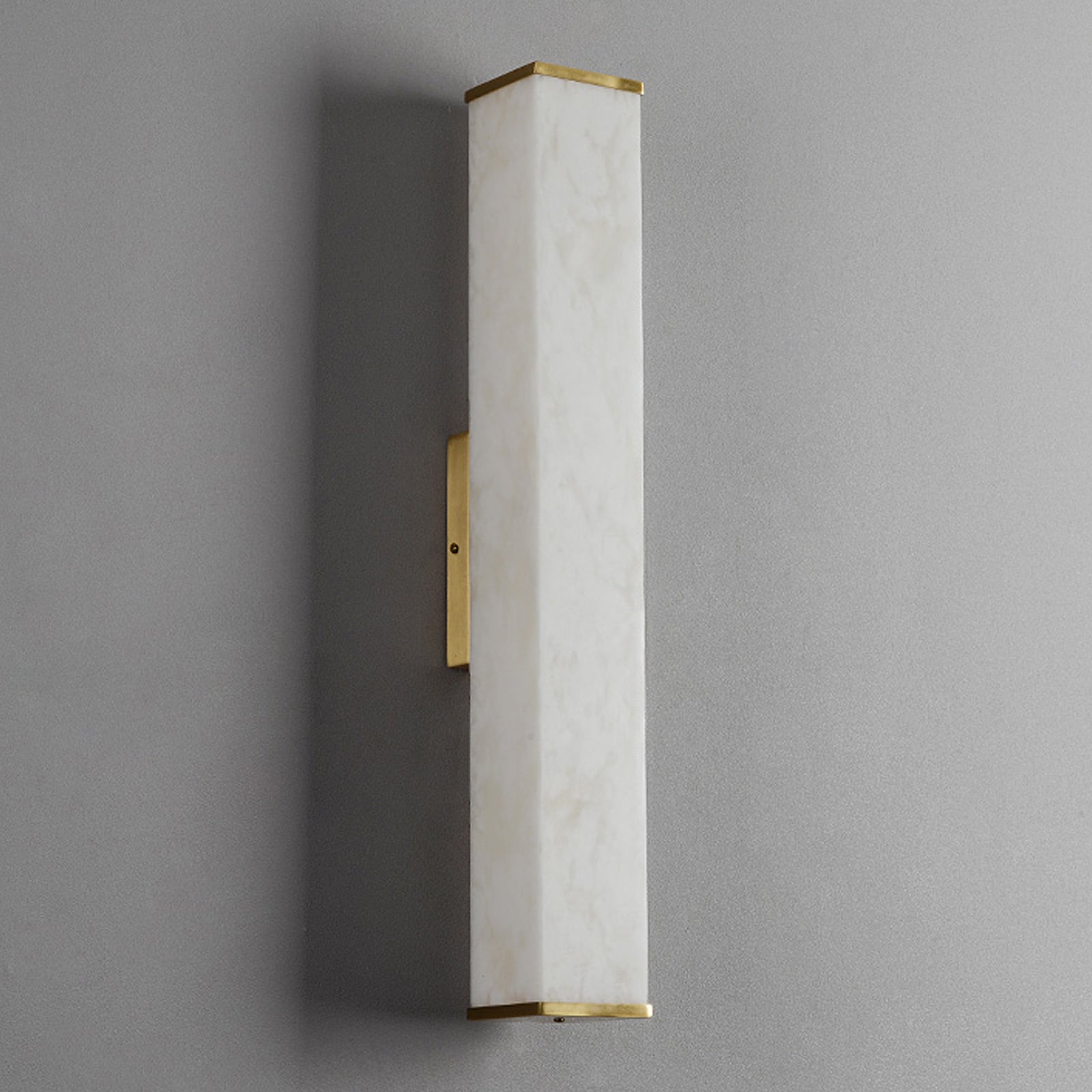 Modern wall sconce light fixture on a gray wall