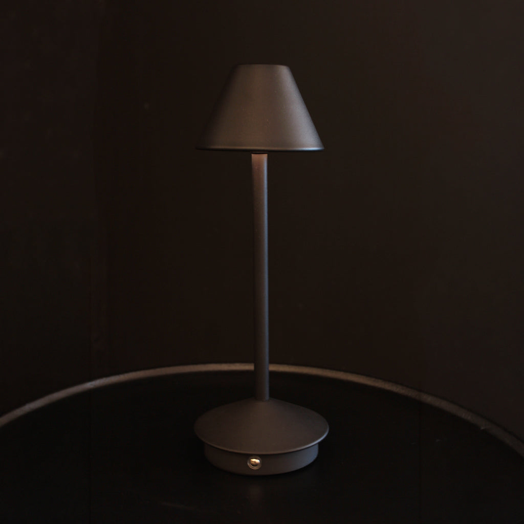 Matt black rechargeable portable table lamp with tapering shade and base