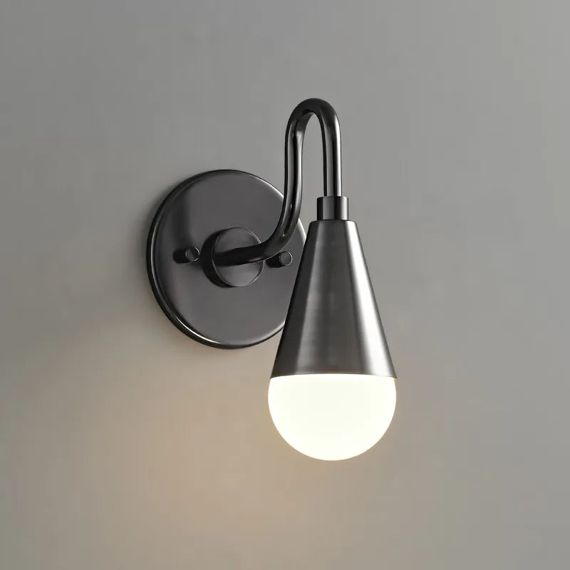 Curved neck wall sconce in metal black finish with white lightbulb on grey wall