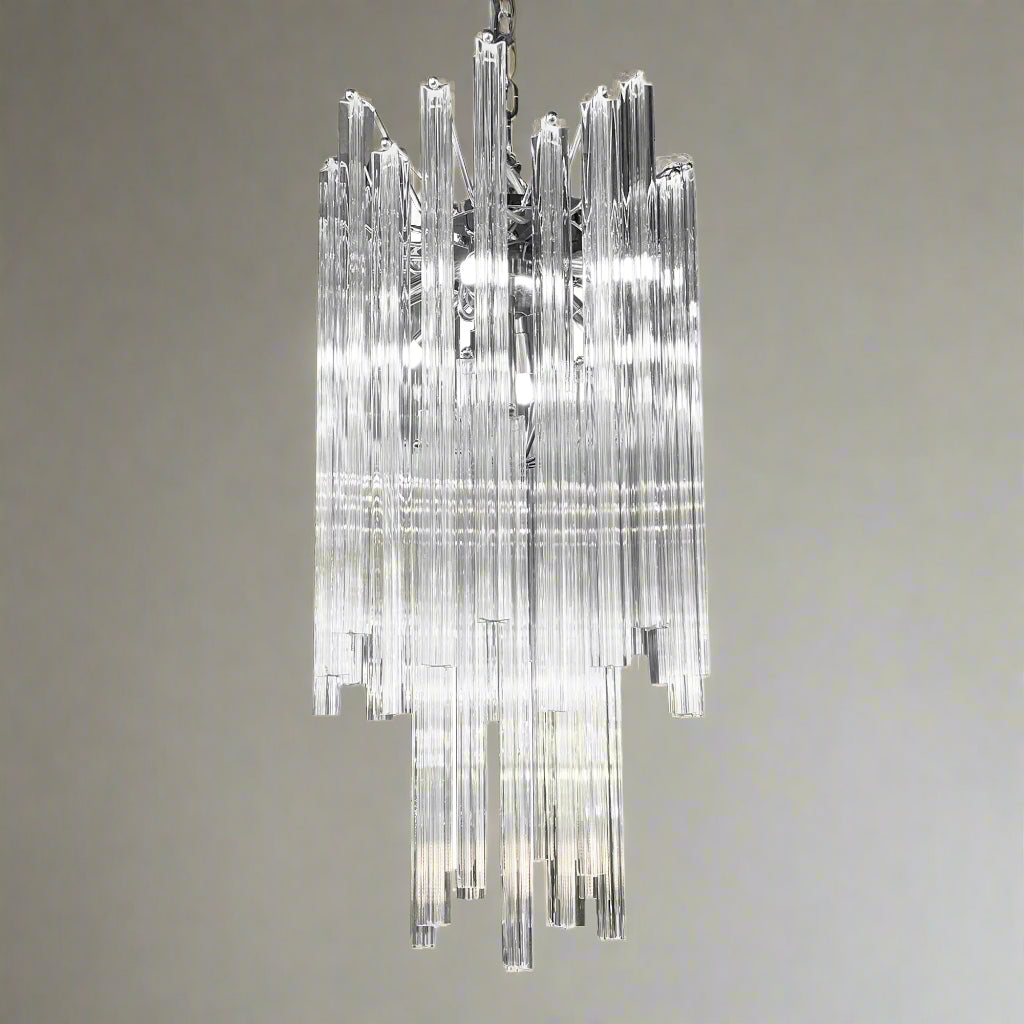 Chandelier hanging above a staircase in a softly lit room