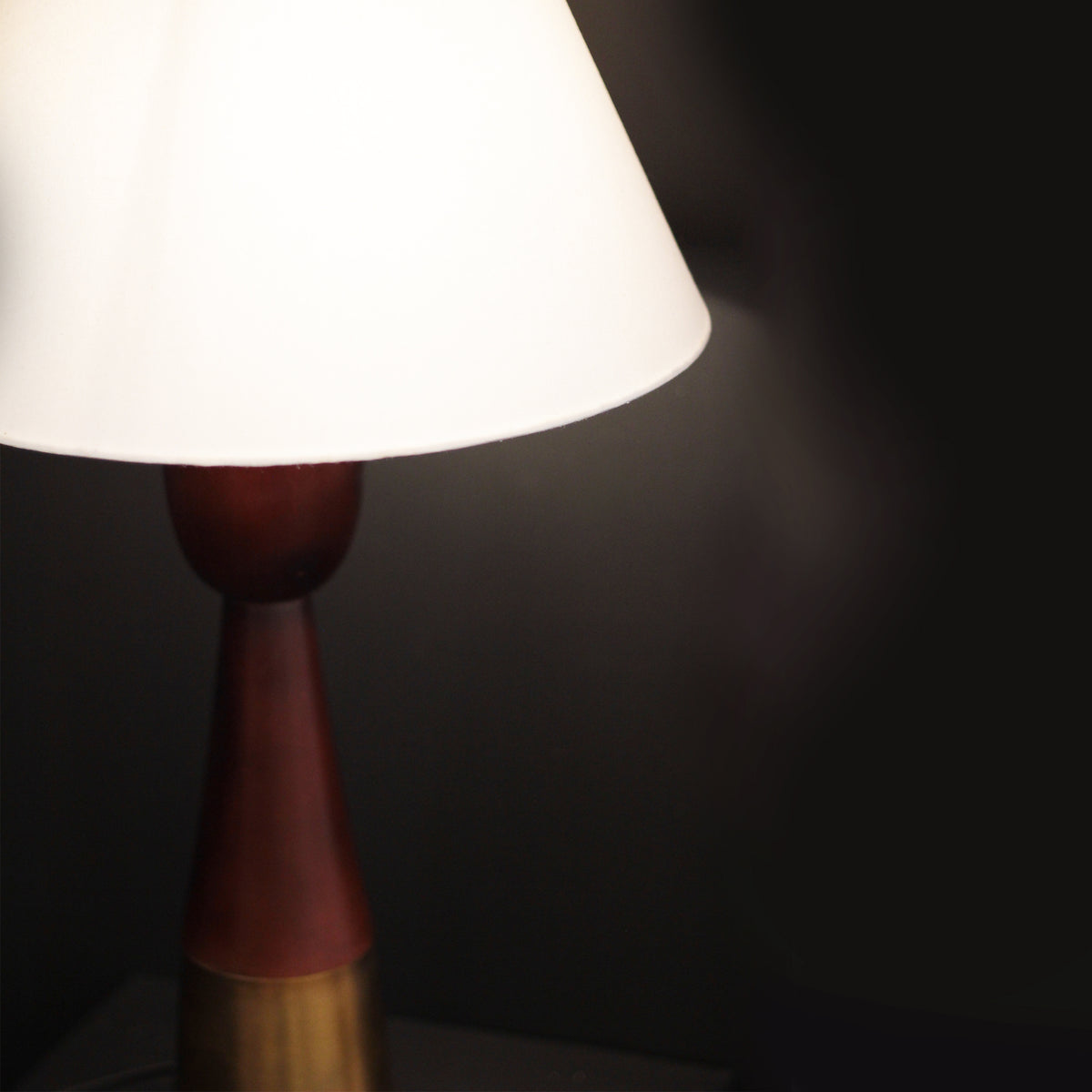 Lamp with a white shade on a dark background