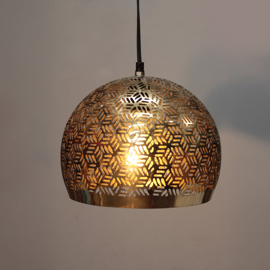 Decorative gold pendant light with geometric pattern on a plain background