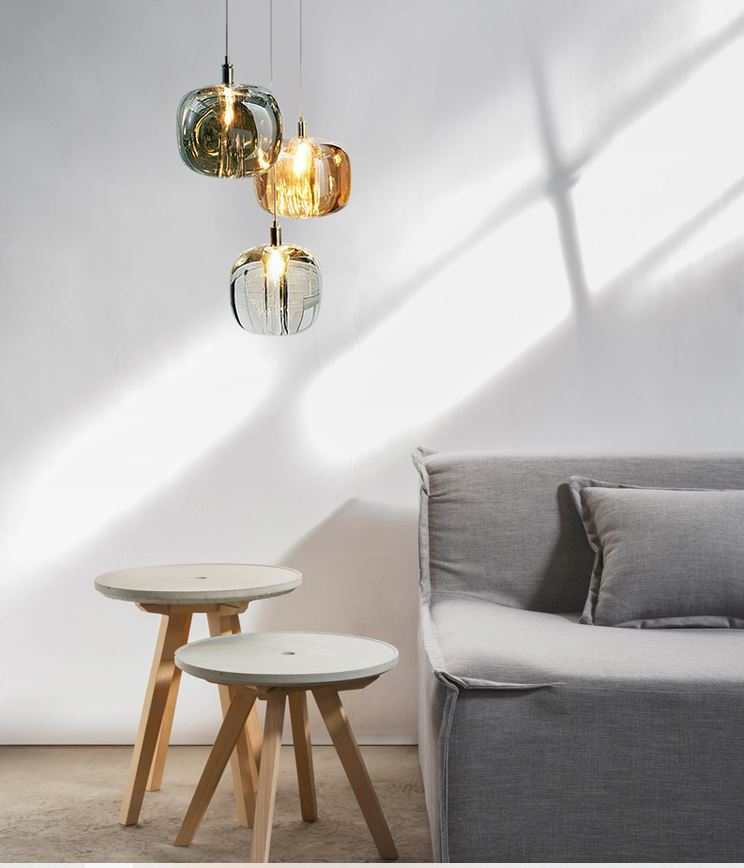 A group of Rocas pendant lights made of solid crystal with chrome fittings, hanging in a cluster to provide minimalist contemporary lighting.