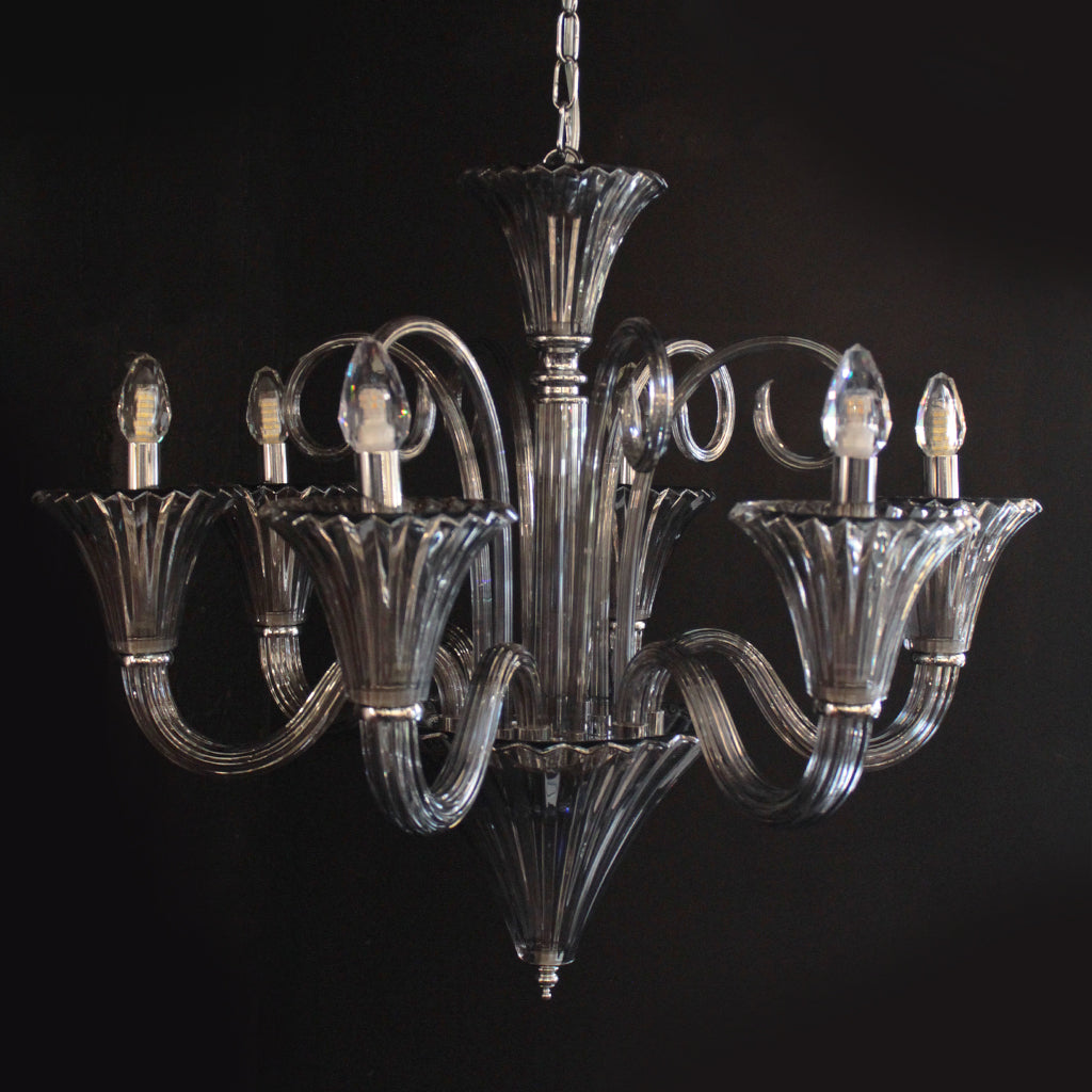 Decorative chandelier with smokey grey arms on a black background