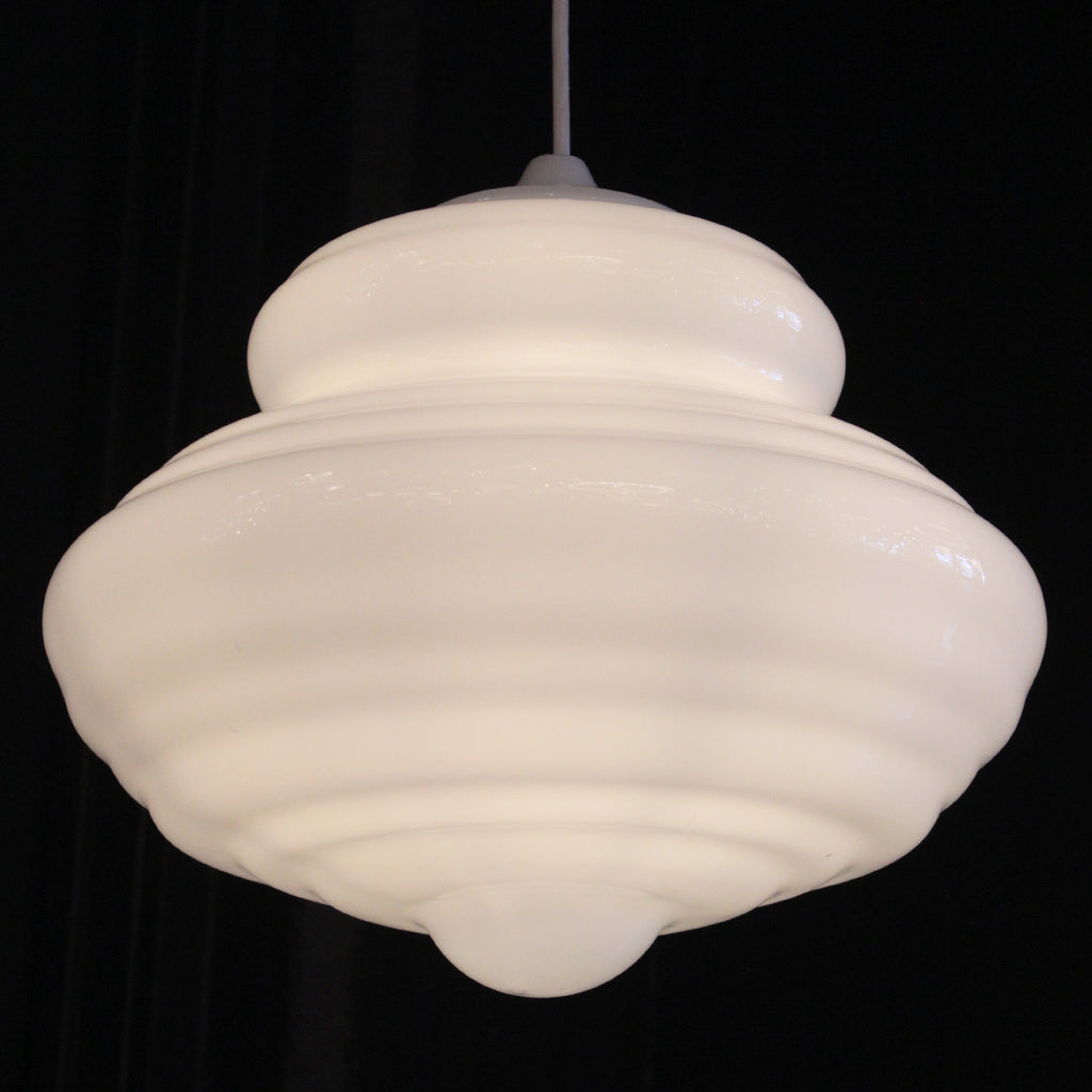 A vintage-style white ribbed glass pendant light with a matching white cord, shown against a solid black background.
