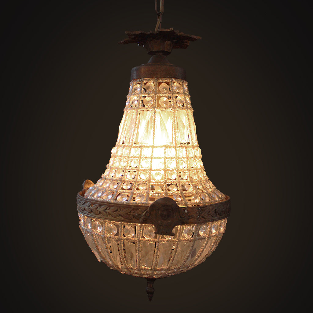Vintage-style chandelier with intricate design on a dark background