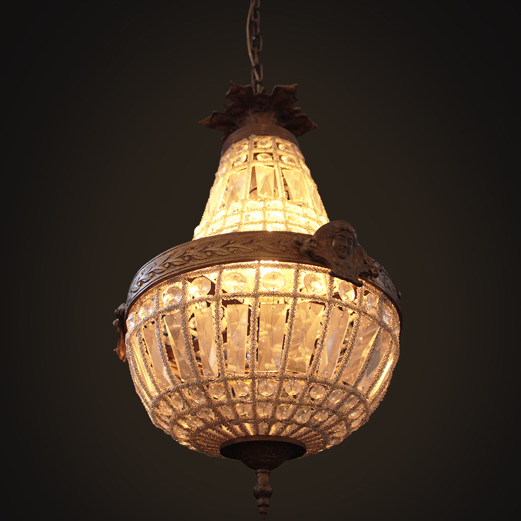 Vintage-style chandelier with intricate design on a dark background