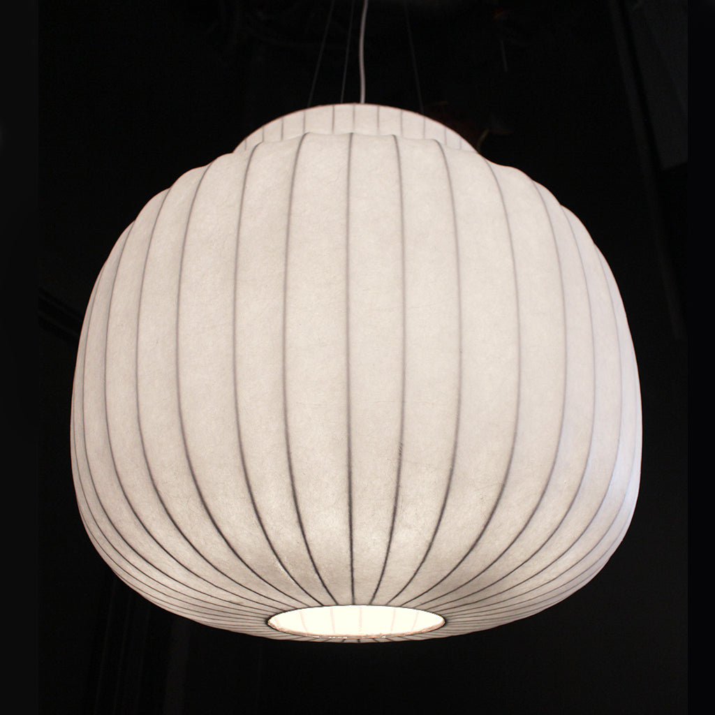 White ribbed pendant light against a black background