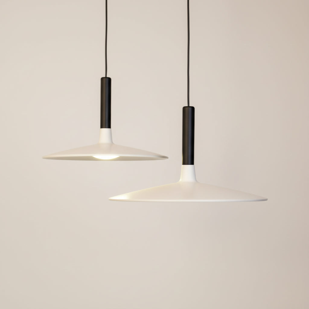 Modern pendant light with two white lampshades on a dark background
