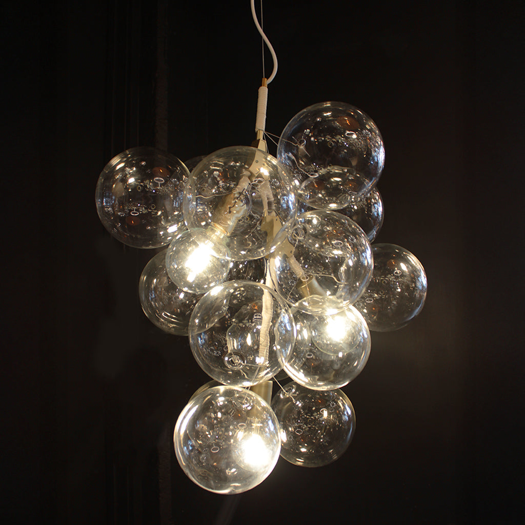 Chandelier with multiple glass bulbs on a dark background