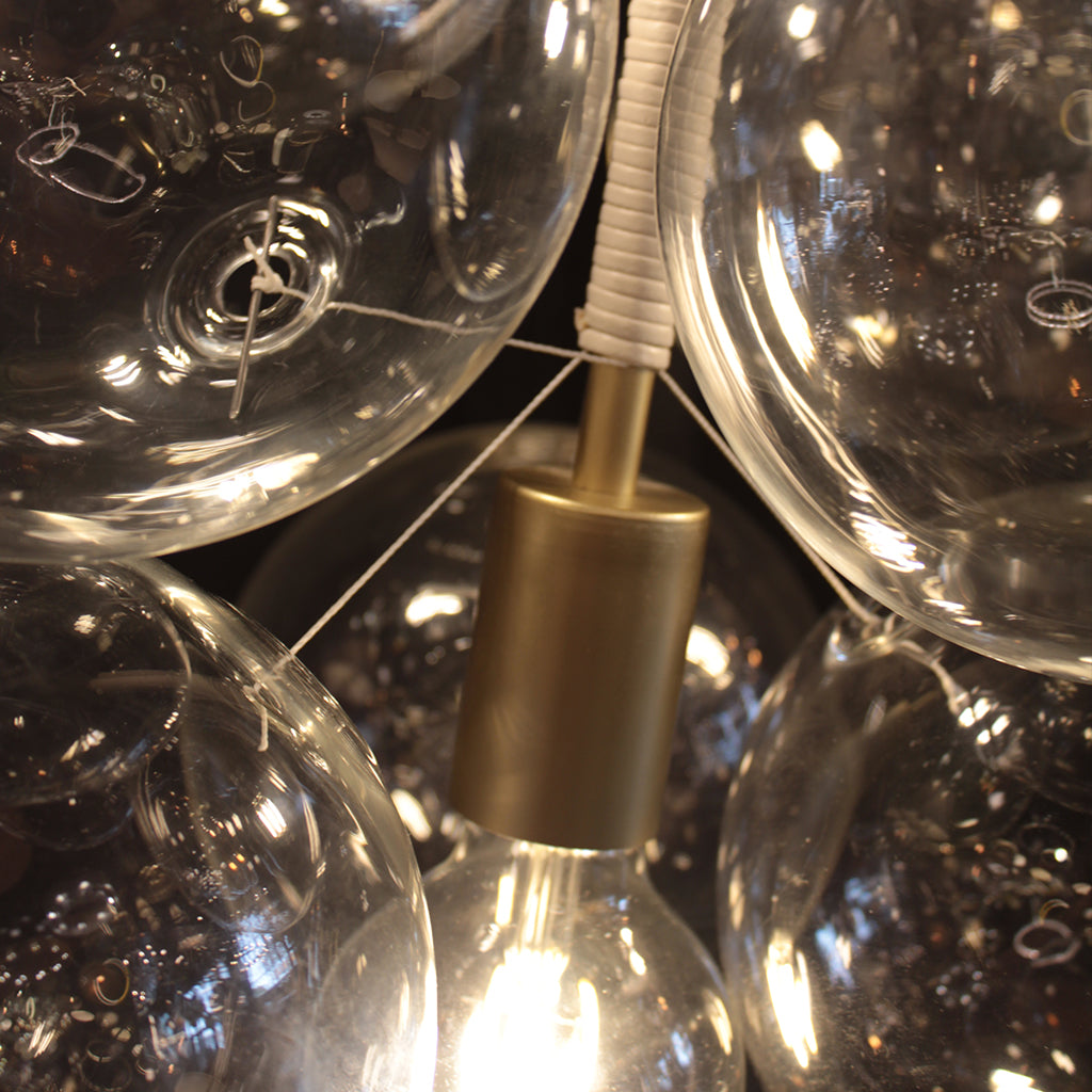 Close-up of clear light bulbs with a gold fixture
