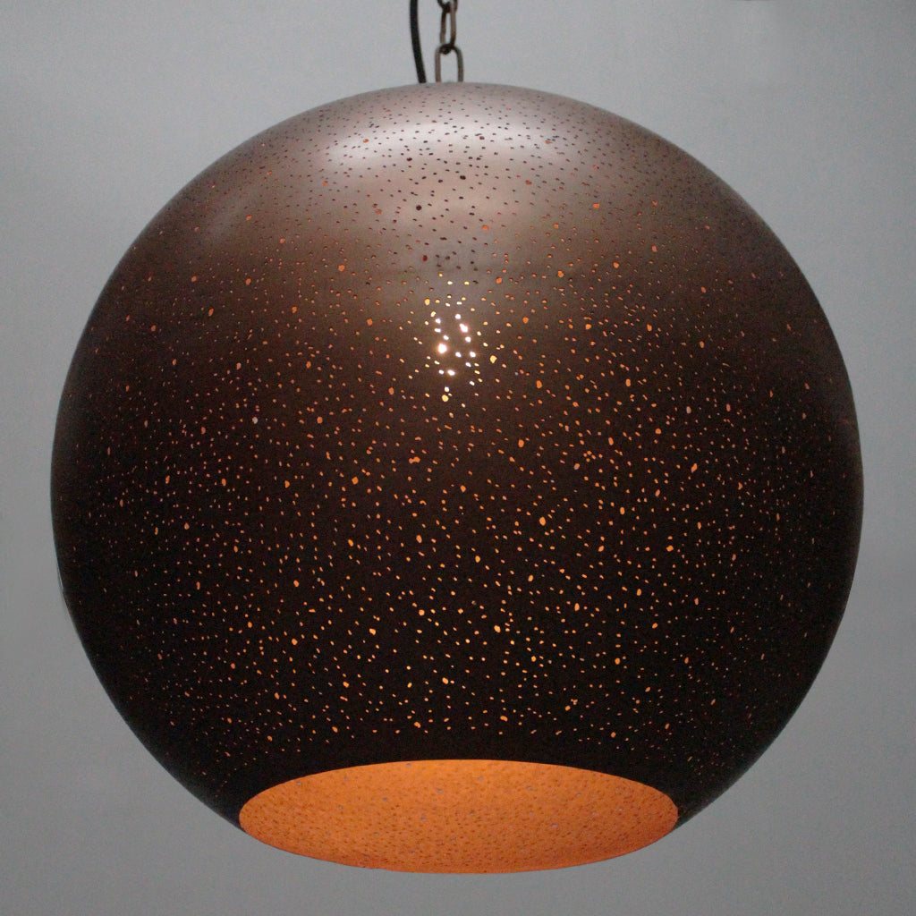Spherical pendant light with speckled design on a gray background