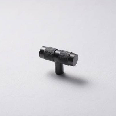 A black brass handle T-pull on a white background.