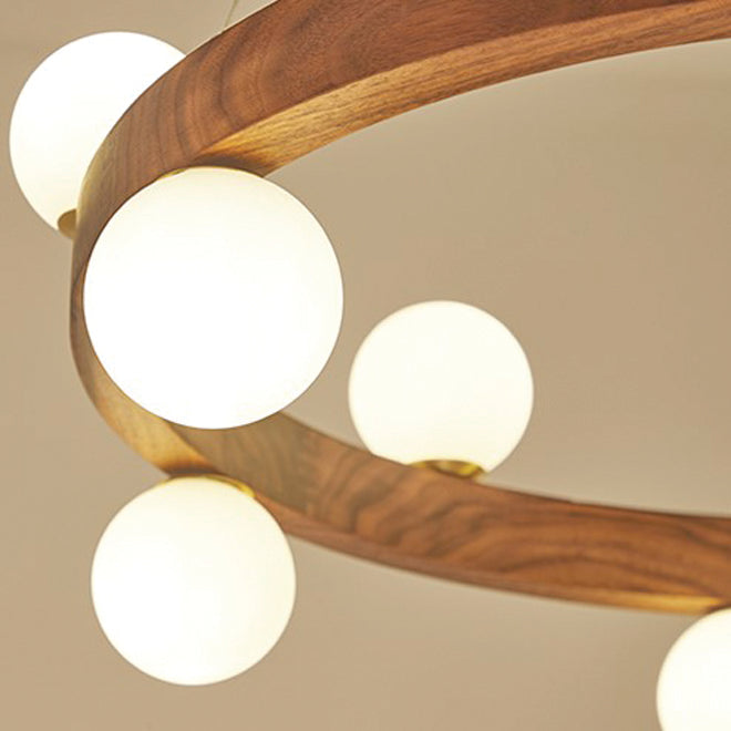Wooden chandelier with multiple round glass lights on a white background